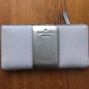 Kate spade creme wallet with gold metallic strip